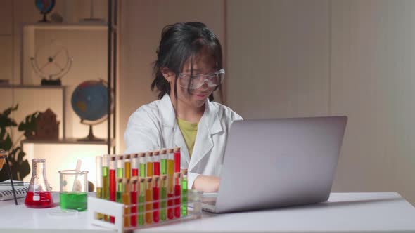 Young Asian Scientist Girl With Dirty Face Using Lap Top Computer In Laboratory