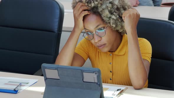 Bored Afro Woman in Front of Computer in an Office