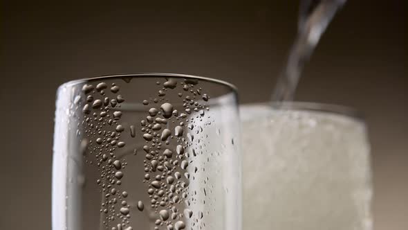 Two Steamy Glass of Champagne Filled To the Brim. Close Up