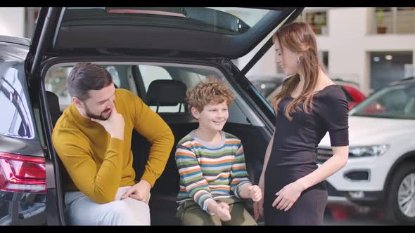 Portrait of Happy Caucasian Family in Car Dealership