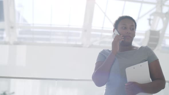 Confident Businesswoman Talking on Phone in Office Center