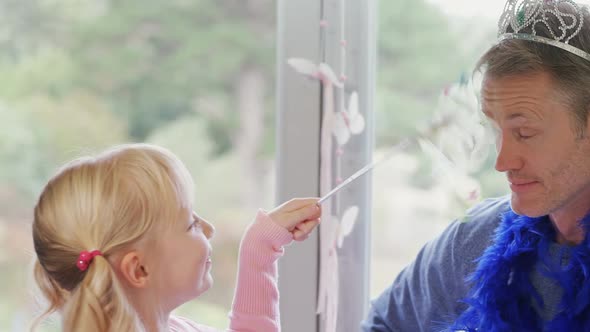 Father and daughter playing with fairy wand