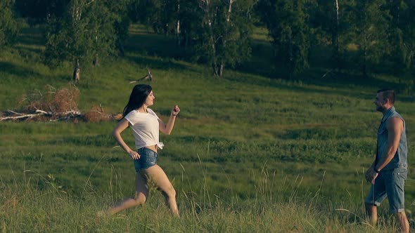 Long Haired Girl Runs To Man and Jumps with Laughter