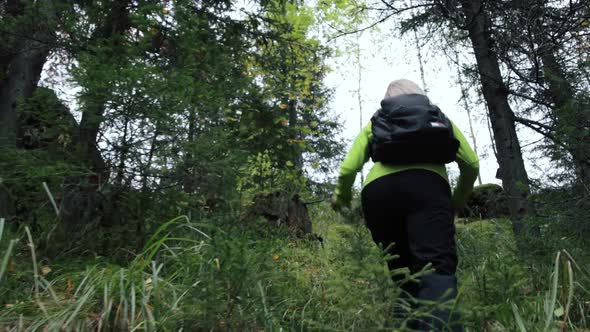 Woman tourist climbing up a hill