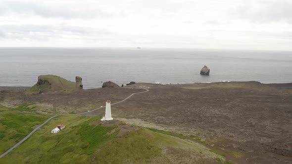 Scenic View Of Cars Traveling On Road With Lighthouse In Geothermal Power Facility In Iceland.