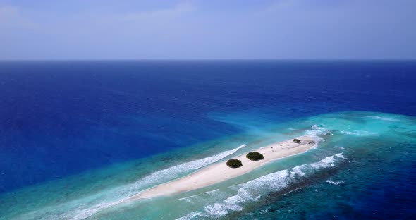 Luxury overhead travel shot of a white paradise beach and aqua blue water background in colorful