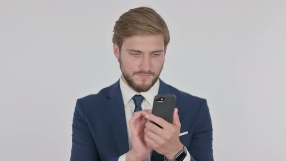 Young Businessman Browsing Smartphone on White Background