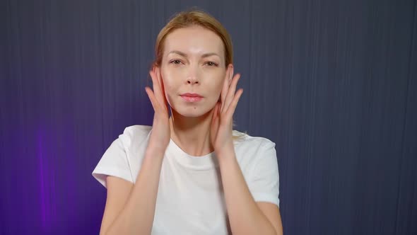 Adult Woman Is Massaging Her Face, Rubbing and Patting Cheeks, Rejuvenating Procedure