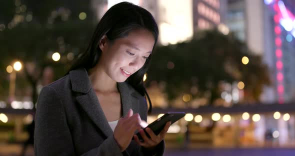 Business woman use of cellphone city city at night