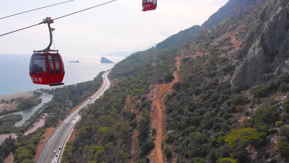 Close-up Flight Next To the Uphill Funicular with the Coast in the Background 