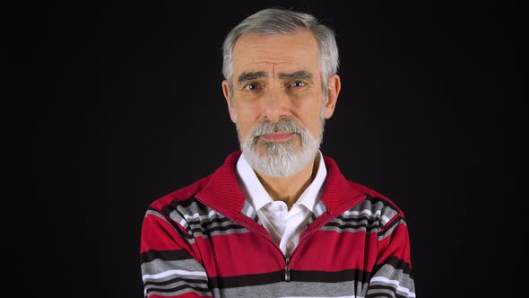 An Elderly Man Shakes His Head at the Camera - Black Screen Studio