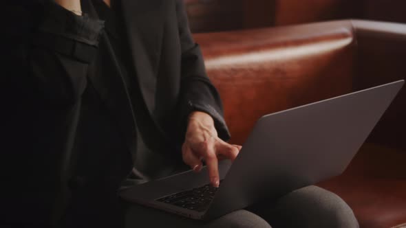 Close Up of a Business Woman Pressing Enter on a Laptop Computer Keyboard