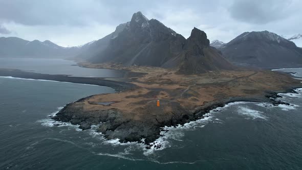 Iceland Dramatic Coastline in the Eastern Fjords with Orange Lighthouse on Iceland's Ring Road