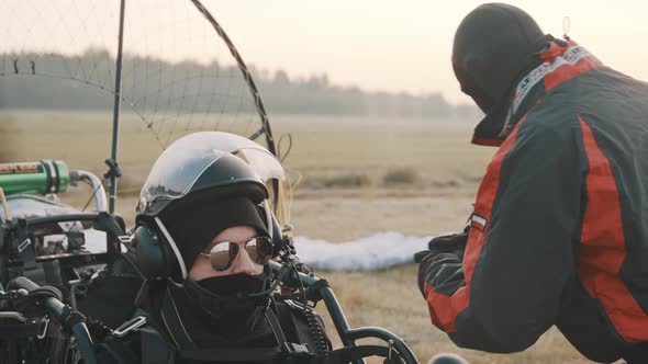 Man Sitting in Paramotor Trike and Concentrating Before Takeoff