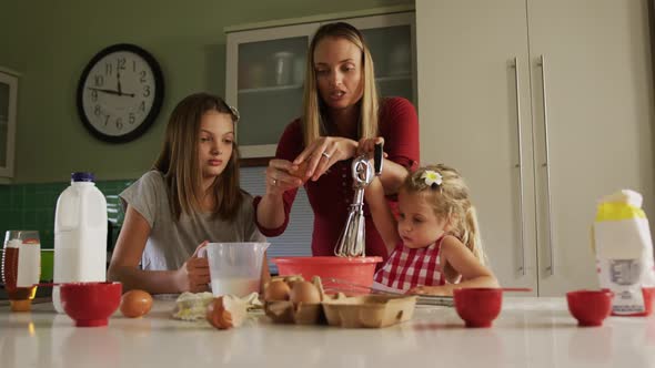 Mother and daughters cooking crepes together