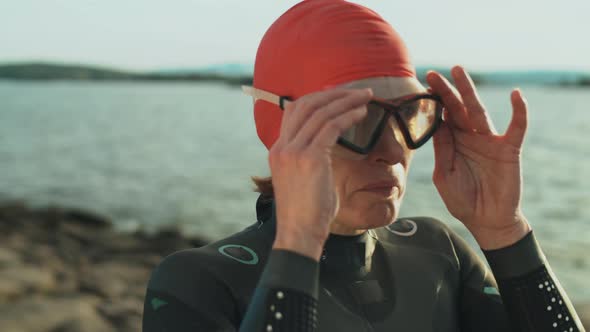 Sportswoman Putting on Swimming Goggles
