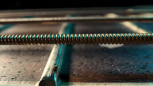 Slider Macro Shot of an Acoustic Guitar Neck with Metal Strings and Frets on a Black Background