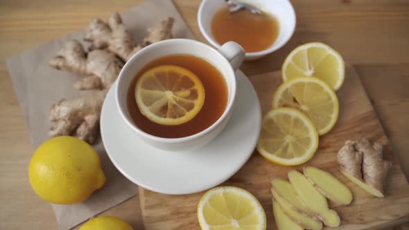 Adding Lemon To Cup of Ginger Tea