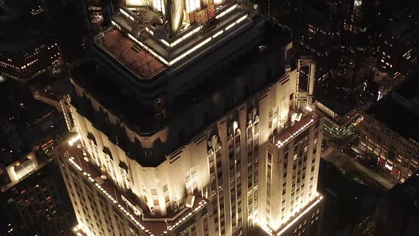 AERIAL: Breathtaking Flight Over the Iconic Empire State Building Above Lit Up Parallel Avenues and