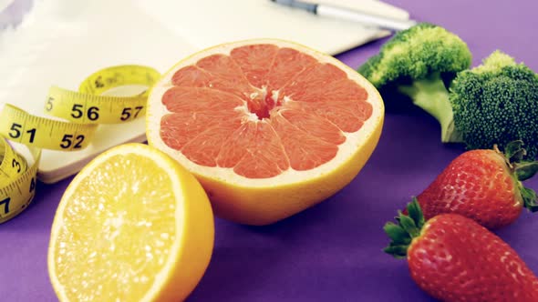 Water bottle, fruits, vegetable, notebook, pen, and measuring tape