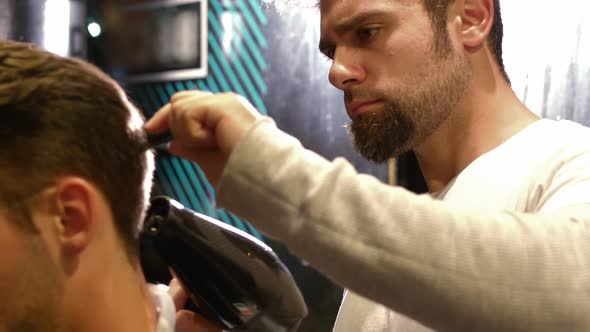 Man getting his hair dried with hair dryer