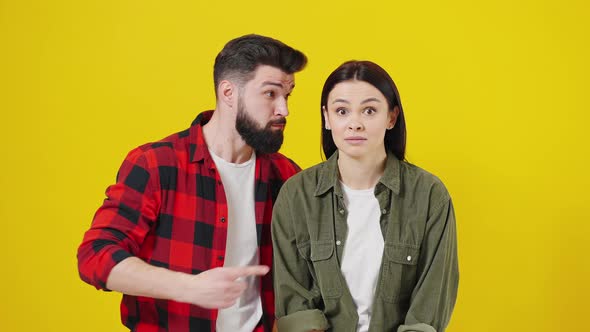 Stunned Millennial Couple Isolated on Yellow Studio Background Shocked By Good Deal or Offer