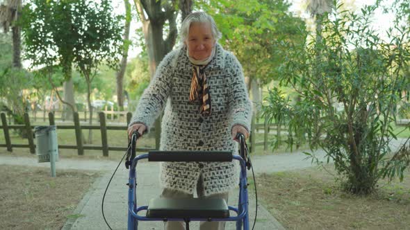 Greyhaired Woman Strolls Using Wheelchairwalker with Smile