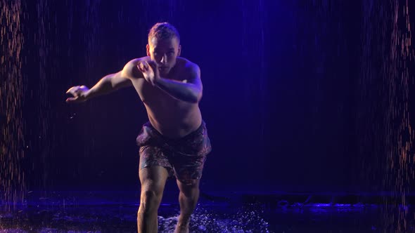 Incredible Capoeira Martial Arts Fighting in the Rain in Slow Motion. Young Male Practicing Martial