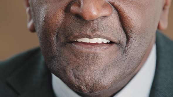 Extreme Close Up Talking Mouth of Old Senior Biracial Businessman Face Part of Speaking Male