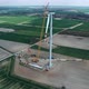 Wind turbine assembly, crane lifts the propeller. Windmill producing electricity under construction. - VideoHive Item for Sale