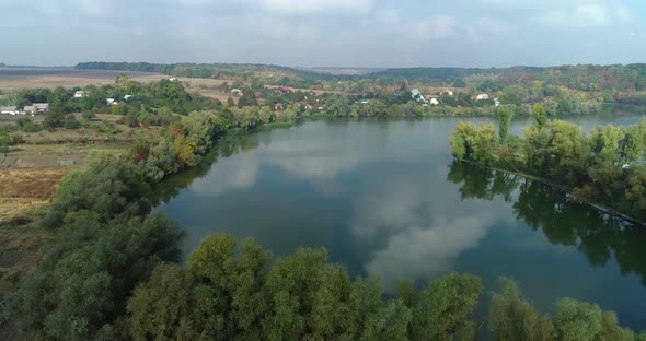 The camera flies over the river in a small town