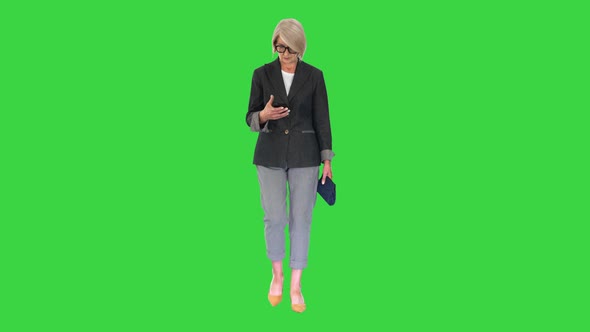 Intelligent Senior Woman Using Smartphone While Walking Green Screen Chroma Key