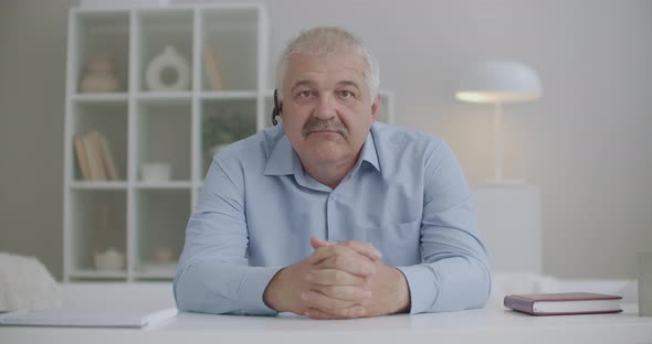 Gray Haired Man Is Looking at Camera and Nodding By Head, Webcam Communication Concept By Video Call