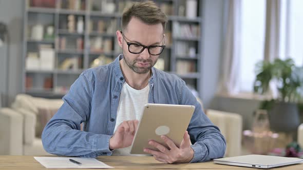 Professional Young Man Using Tablet in Office