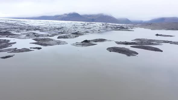 Flying Over Melting Icebergs in Svinafellsjokull Glacial Lake, Iceland