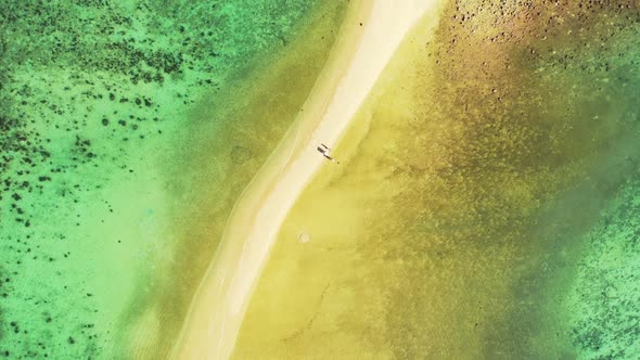 Aerial drone abstract of idyllic shore beach journey by blue sea with clean sand background of a day