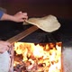 Female making bread In the oriental courtyard. Lit the firewood to bake bread - VideoHive Item for Sale