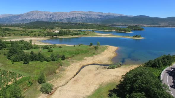 Flying above green environment of artificial lake Peruca, Croatia