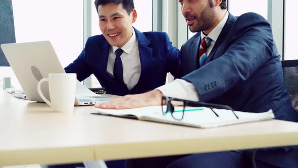 Two Business People Talk Project Strategy at Office