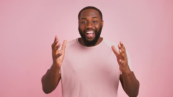 Joyful African American Guy Enjoying Success Can't Believe His Win Pink Background