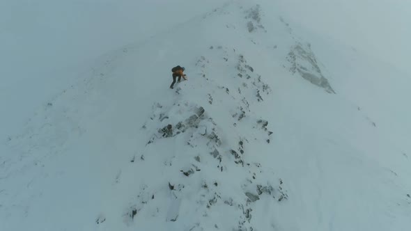 Mountain Climber Traversing a Snowy Rock Face
