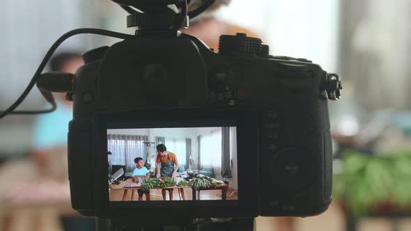 Display Camera Of Father And Son Streaming Live Video With Camera While Cooking At Home