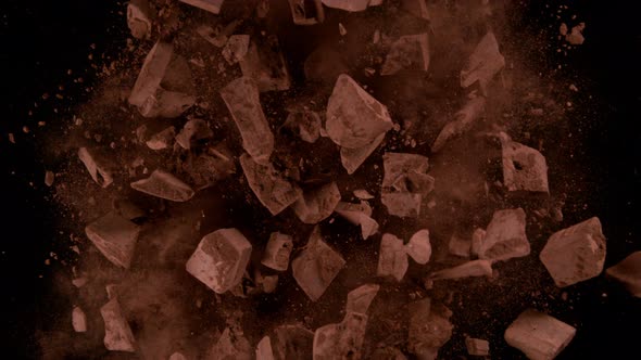 Super Slow Motion Shot of Rotating Chocolate Chunks and Cocoa Powder Explosion at 1000Fps alt