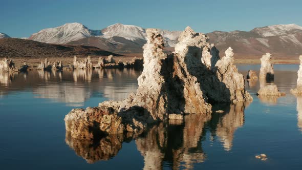 Camera Moving Around Amazing Pike Stones Reflecting in the Blue Surface, 