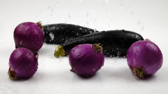 Washing vegetables, eggplant and red onions