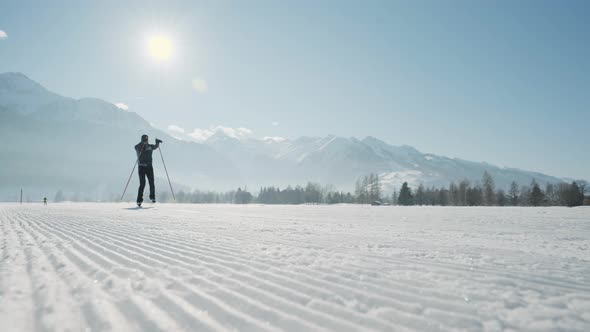 Cross Country Skier Skiing Along Snowy Path