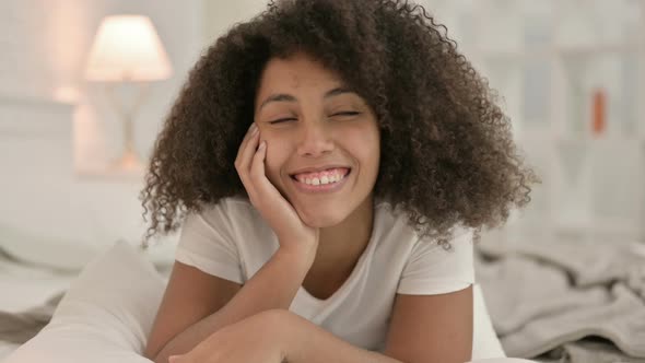 Portrait of Video Chat By Young African Woman Laying in Bed