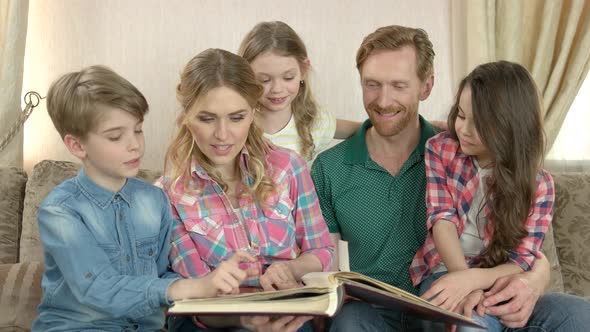 Family with Photo Album Indoors.