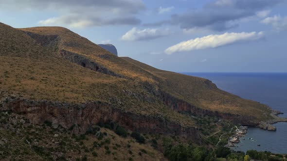 Panning of Sicilian Riserva dello Zingaro natural reserve in Sicily with mountains cliffs and coves.