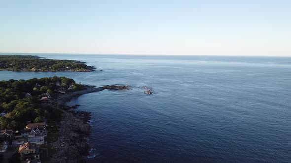 Aerial drone video of the ocean coastline and homes at Short Sands Beach near Cape Neddick and York,